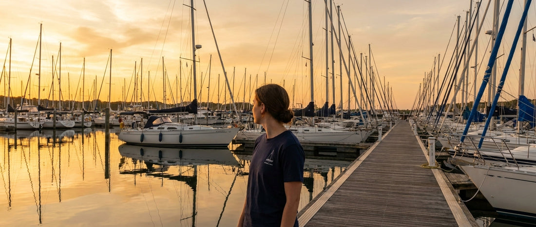 Row of production cruising sailboats in a marina at sunset